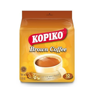 The image shows the packaging for Kopiko Brown Coffee Mix. The design features a warm, golden-yellow color scheme, emphasizing the name "Kopiko" in bold red and white, with "Brown Coffee" written below in white text. A steaming cup of coffee is displayed at the center, with coffee beans shown near the bottom left corner. The tagline reads "Just the Right Blend," highlighting its balanced flavor. The package contains 10 sachets with a total net weight of 8.8 oz (250g).