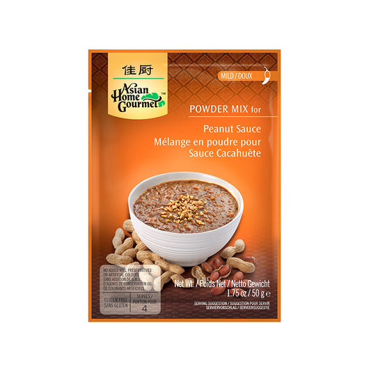 Asian Home Gourmet Powder Mix for Indonesian peanut sauce in 1.75 oz orange sachet. A bowl of saucy peanut with crush peanuts topping served on a white bowl is pictured. Also pictured shelled peanuts around the bowl. The sachet is labeled Mild level of spiciness.