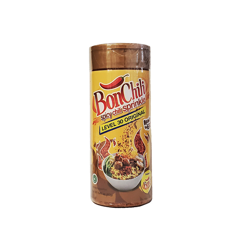 Kobe Bon Chili (Spicy Chili Sprinkle) Level 30 Super Extra Hot in a gold / yellow label easy to pour pet bottle. A bowl of noodle and meatball sprinkled with chili flakes is pictured.