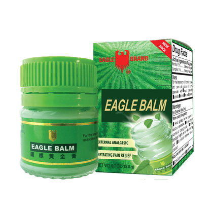 Eagle Balm in green container. An external analgesic for pain relief. Pictures of leaves shown in the packaging.