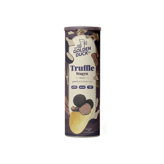 A cylindrical can of The Golden Duck Truffle Wagyu Spiced Potato Crisps (125g). The packaging is dark brown with illustrations of truffle mushrooms, thinly sliced Wagyu beef, and seasoned crisps. The Golden Duck logo, featuring a cartoon duck illustration, is displayed at the top. The label highlights that the crisps are made with real black truffle and have no added preservatives, are non-GMO, and gluten-free.