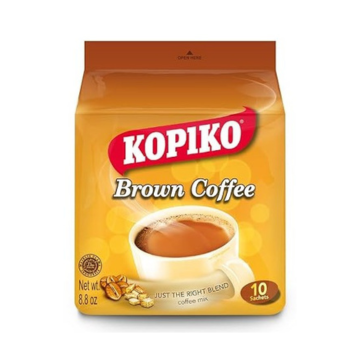 The image shows the packaging for Kopiko Brown Coffee Mix. The design features a warm, golden-yellow color scheme, emphasizing the name "Kopiko" in bold red and white, with "Brown Coffee" written below in white text. A steaming cup of coffee is displayed at the center, with coffee beans shown near the bottom left corner. The tagline reads "Just the Right Blend," highlighting its balanced flavor. The package contains 10 sachets with a total net weight of 8.8 oz (250g). 